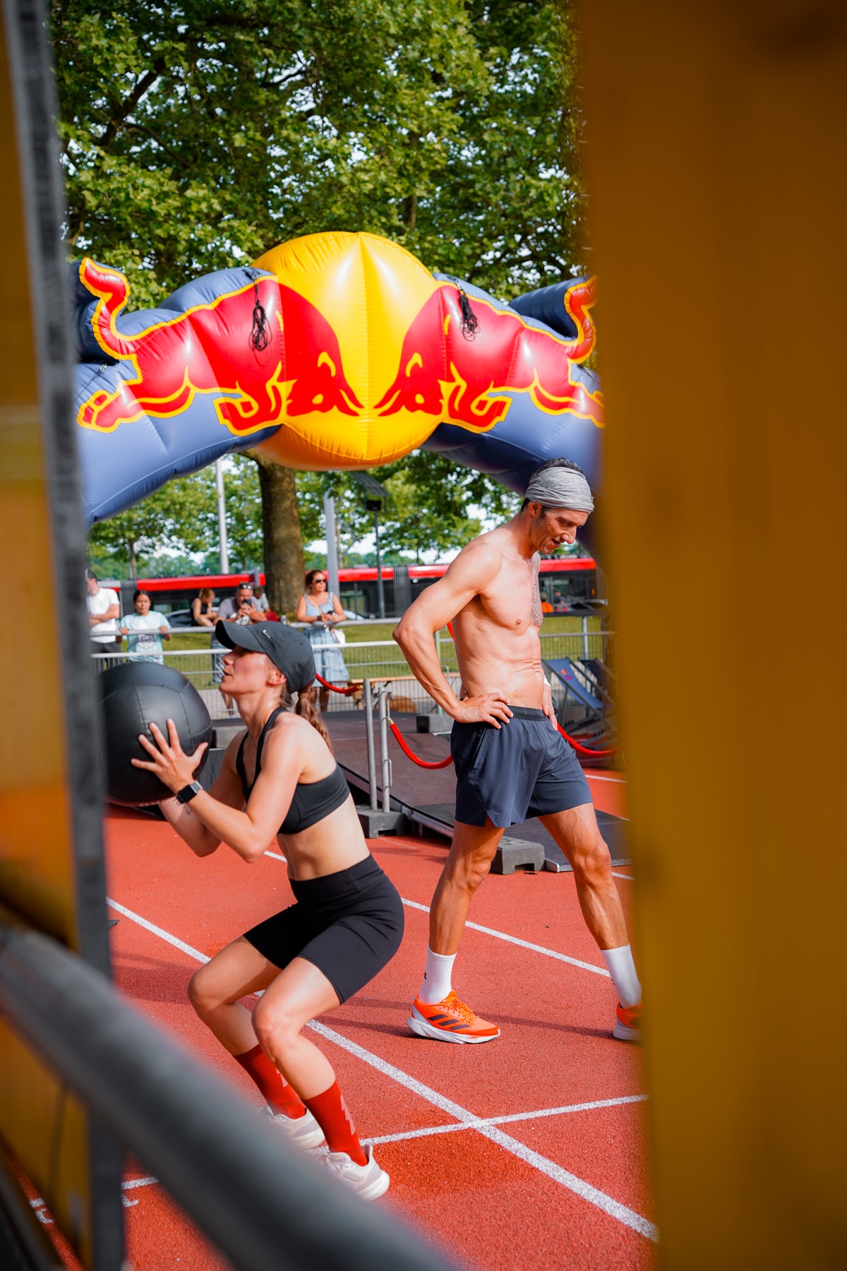 Zwei Athlet:innen unter dem Red-Bull-Bogen im Zieleinlauf
